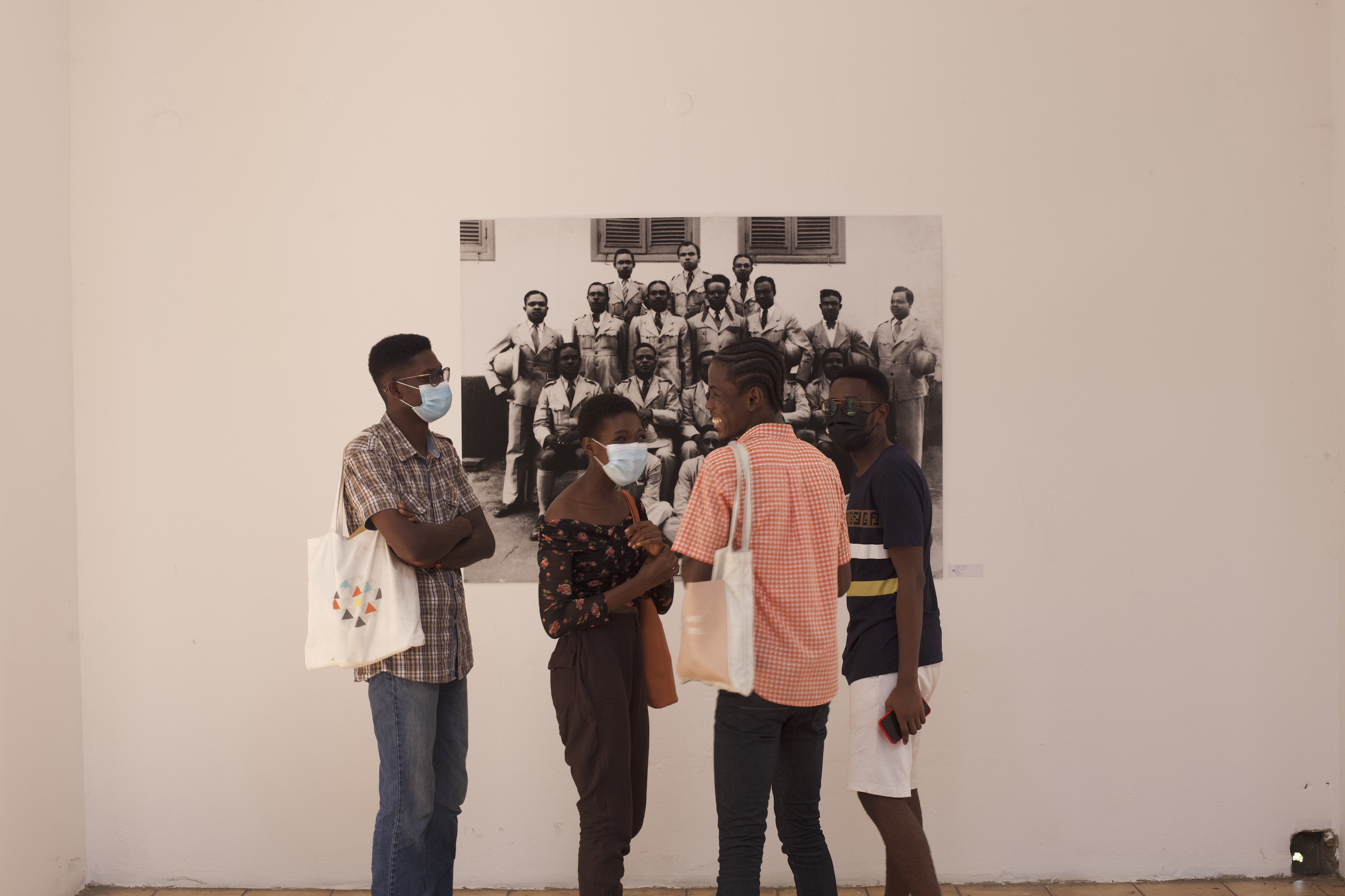Visitors to the exhibition Simply Iconic spend some time discussing work on display at the Museum of Science and Technology, Accra